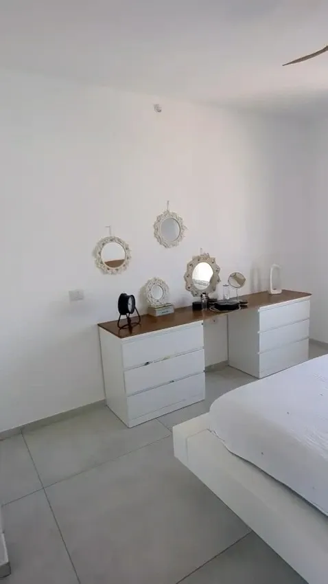 Master bedroom in Netanya before: large white wall behind the dressers